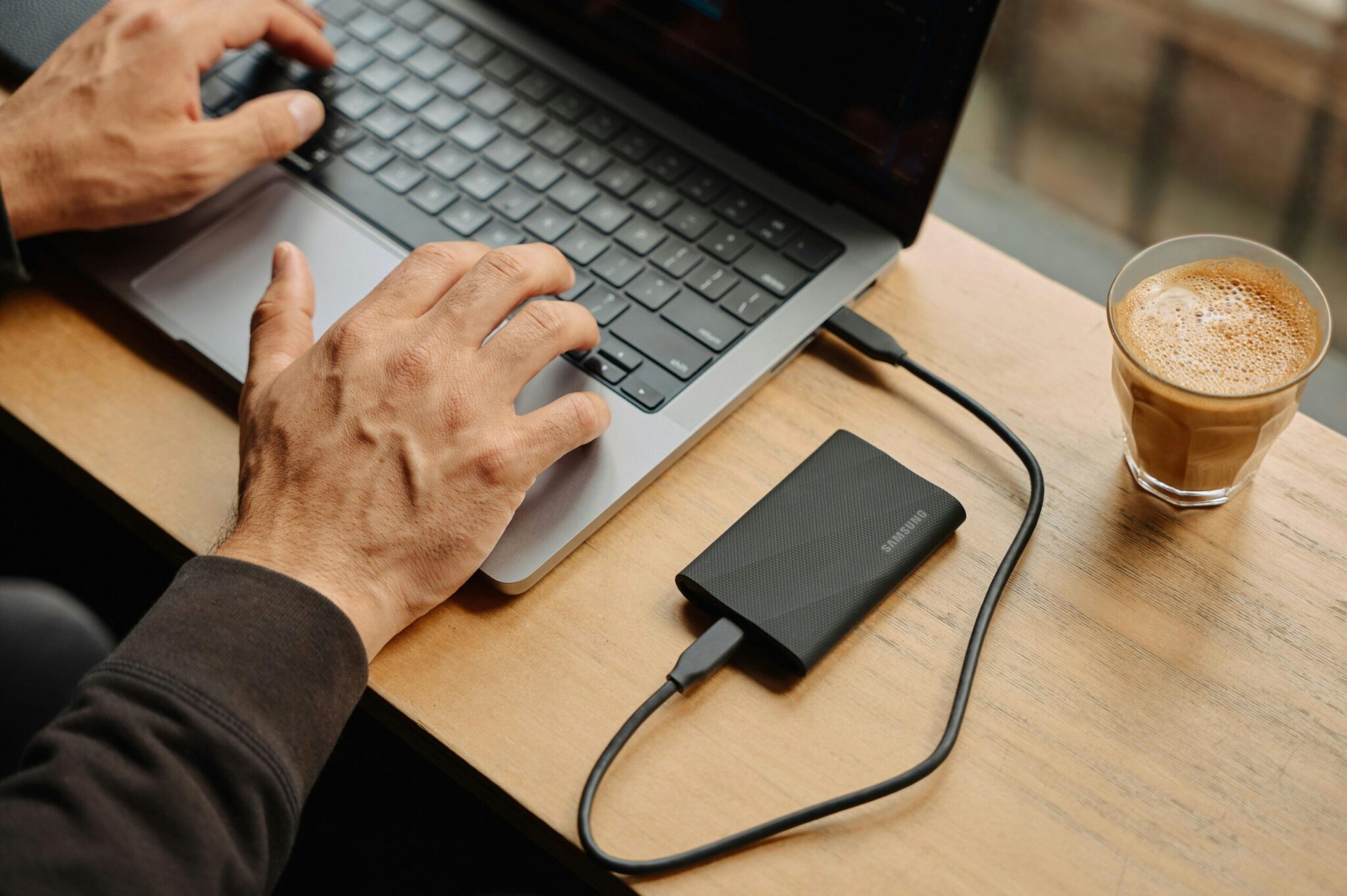 How-Much-Device-Storage-You-Need_-A-Comprehensive-Guide-scaledjpg | ALCON DTS: Austin Best Managed IT Support Services A man sitting at a table using a laptop computer