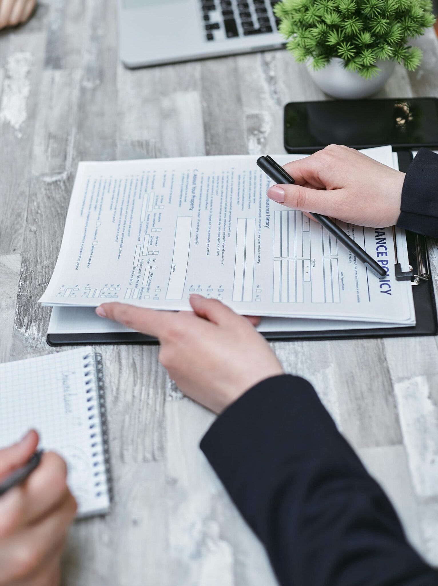 pexels-mikhail-nilov-7731326-scaledjpg | ALCON DTS: Austin, TX Best Managed IT Support Services Close-up of hands analyzing insurance policy paperwork with pen on table. Stock Photo